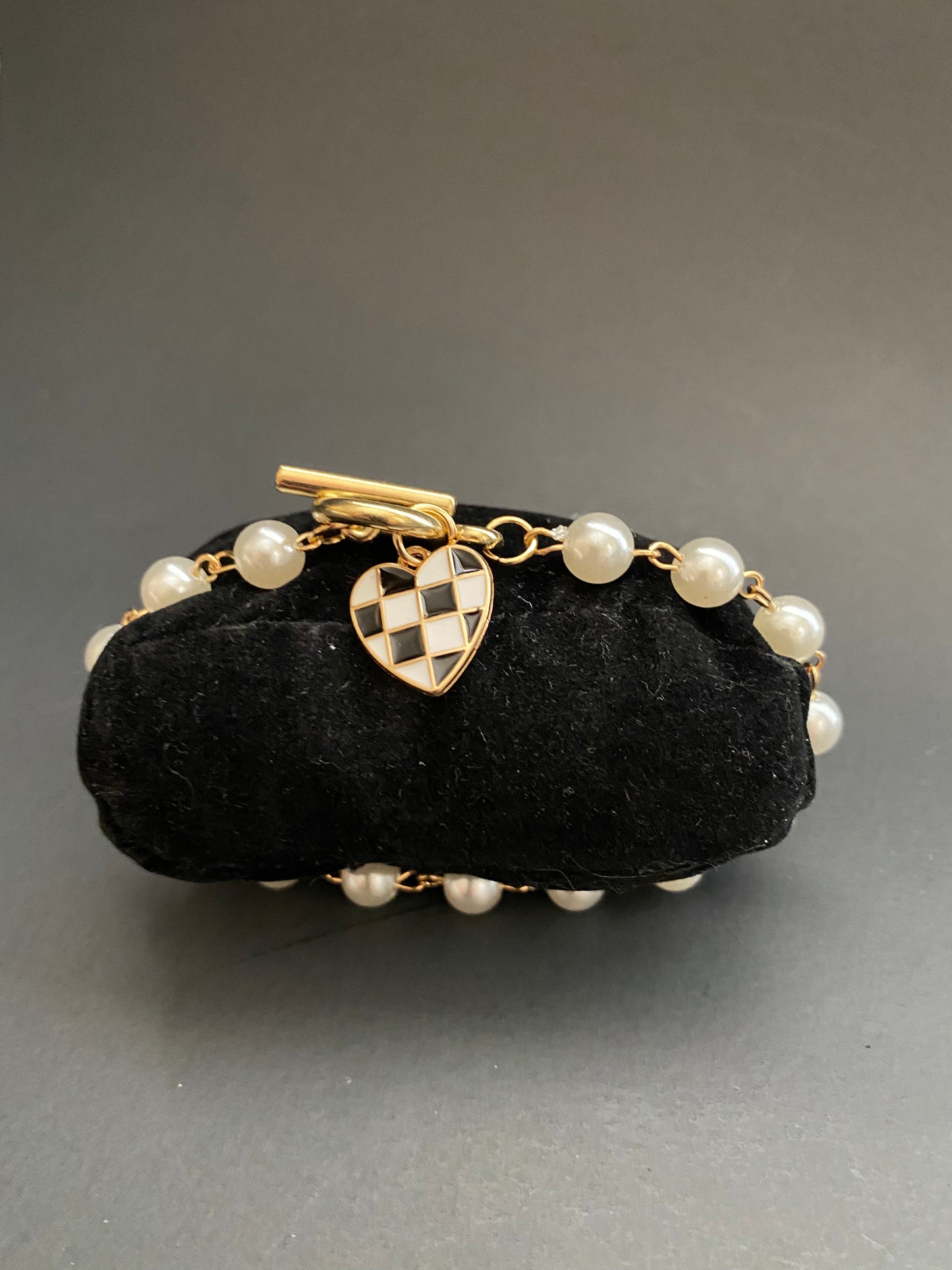 Pearl toggle bracelet with gold checkered heart charm