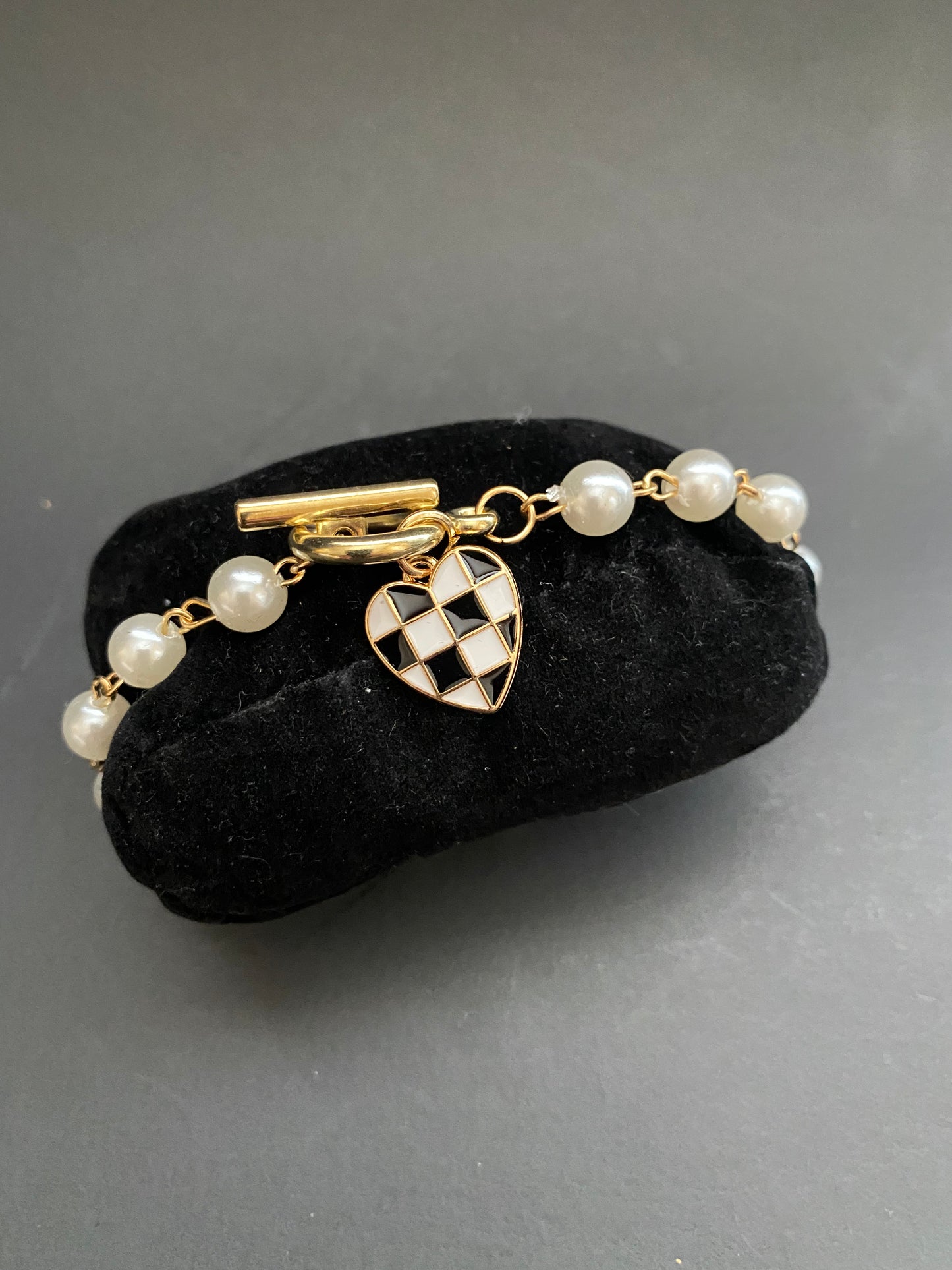 Pearl toggle bracelet with gold checkered heart charm